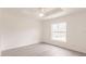 Clean, bright bedroom with natural light from a large window at 27456 Corinthian Dr, Punta Gorda, FL 33955