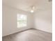 Sunlit bedroom features a window and ceiling fan at 27456 Corinthian Dr, Punta Gorda, FL 33955