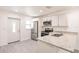 Stylish kitchen featuring stainless steel appliances, granite countertops, and white cabinets at 27456 Corinthian Dr, Punta Gorda, FL 33955