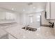 Modern kitchen with granite countertops and stainless steel appliances near the entry door at 27456 Corinthian Dr, Punta Gorda, FL 33955