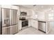 Open kitchen featuring stainless steel appliances, granite countertops, white cabinets and durable gray floors at 27456 Corinthian Dr, Punta Gorda, FL 33955