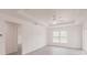 Bright living room with large windows and sliding glass door, offering ample natural light and a smooth gray floor at 27456 Corinthian Dr, Punta Gorda, FL 33955