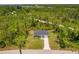 Aerial shot of a single-story home surrounded by trees and a long driveway at 28218 N Twin Lakes Dr, Punta Gorda, FL 33955