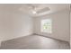 Bright bedroom features a ceiling fan, a window with natural light, and light-colored flooring at 28218 N Twin Lakes Dr, Punta Gorda, FL 33955