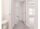 Hallway leading to a bedroom and bathroom with a toilet at 28218 N Twin Lakes Dr, Punta Gorda, FL 33955
