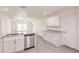 Bright, all-white kitchen featuring stainless steel appliances, granite countertops, and ample cabinet space at 28218 N Twin Lakes Dr, Punta Gorda, FL 33955