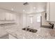 Kitchen featuring granite countertops, stainless steel sink and appliances, plus ample cabinet space at 28218 N Twin Lakes Dr, Punta Gorda, FL 33955