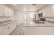 Well-lit kitchen with white cabinets, granite countertops, and stainless steel appliances at 28218 N Twin Lakes Dr, Punta Gorda, FL 33955