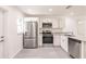 Modern kitchen features stainless steel appliances, granite countertops, and ample natural light at 28218 N Twin Lakes Dr, Punta Gorda, FL 33955