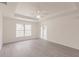Spacious main bedroom featuring sleek vinyl flooring, a large window, and a sliding glass door at 28218 N Twin Lakes Dr, Punta Gorda, FL 33955