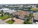 Stunning aerial view of the property, showcasing its beautiful landscaping, brick driveway and tile roof at 2833 La Mancha Ct, Punta Gorda, FL 33950