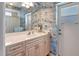 Bright bathroom features fish-themed wallpaper and a vanity with ample storage at 2833 La Mancha Ct, Punta Gorda, FL 33950