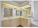 Bathroom featuring dual sinks, recessed lighting, a large mirror, a separate tub, and glass block shower at 2833 La Mancha Ct, Punta Gorda, FL 33950