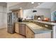 Bright kitchen with stainless steel appliances, breakfast bar, and view into the adjacent living spaces at 2833 La Mancha Ct, Punta Gorda, FL 33950