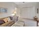 Cozy living room features neutral carpet, a comfortable couch, and tasteful decor at 2833 La Mancha Ct, Punta Gorda, FL 33950