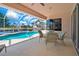 Covered patio and screened pool area offering a scenic view of the canal at 2833 La Mancha Ct, Punta Gorda, FL 33950