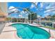 Screened pool with canal view offers an inviting space for relaxation and outdoor enjoyment at 2833 La Mancha Ct, Punta Gorda, FL 33950