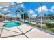 The screened pool and canal offer an inviting space for relaxation and outdoor enjoyment at 2833 La Mancha Ct, Punta Gorda, FL 33950