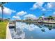 Gorgeous waterfront view features multiple docks, a canal, and sunny skies at 2833 La Mancha Ct, Punta Gorda, FL 33950