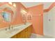 Bathroom featuring dual sinks, decorative mirrors, and a walk-in shower at 3027 Ridgewood Dr, North Port, FL 34287