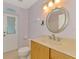 A bathroom featuring a toilet, marble countertops, vanity, and a mirror at 3027 Ridgewood Dr, North Port, FL 34287