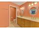 Updated bathroom featuring double vanities, granite countertops, and decorative mirrors at 3027 Ridgewood Dr, North Port, FL 34287