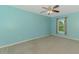 A serene bedroom with carpet, ceiling fan and a window with a view of the outside at 3027 Ridgewood Dr, North Port, FL 34287