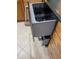 Open dishwasher with stainless steel handle and gray interior in a kitchen with tiled floors at 3027 Ridgewood Dr, North Port, FL 34287