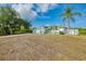 Beautiful single-story home with a lush front lawn, a two car garage, and turquoise trim at 3027 Ridgewood Dr, North Port, FL 34287