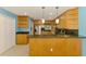 Kitchen featuring stainless steel appliances, dark granite countertops, and light wood cabinetry at 3027 Ridgewood Dr, North Port, FL 34287