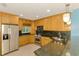 Modern kitchen with stainless steel appliances, granite counters, and light wood cabinets at 3027 Ridgewood Dr, North Port, FL 34287