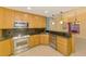 Updated kitchen with granite countertops, stainless steel appliances, and wood cabinetry at 3027 Ridgewood Dr, North Port, FL 34287