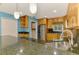 Bright kitchen featuring stainless steel appliances, dark granite countertops, and light wood cabinetry at 3027 Ridgewood Dr, North Port, FL 34287
