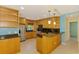 Bright kitchen featuring stainless steel appliances, dark granite countertops, and light wood cabinetry at 3027 Ridgewood Dr, North Port, FL 34287