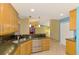 Open kitchen featuring granite countertops, stainless appliances, and bar seating area at 3027 Ridgewood Dr, North Port, FL 34287