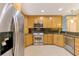 Bright kitchen features stainless steel appliances, granite countertops, and tile flooring at 3027 Ridgewood Dr, North Port, FL 34287