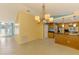 Open concept area adjacent to kitchen with tile flooring and natural light at 3027 Ridgewood Dr, North Port, FL 34287