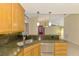 Kitchen features granite countertops, stainless steel appliances, and breakfast bar at 3027 Ridgewood Dr, North Port, FL 34287