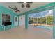 Spacious lanai featuring ceiling fans, a TV, with views of the pool and lush greenery at 3027 Ridgewood Dr, North Port, FL 34287