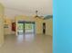 Spacious living room with tile flooring and large sliding glass doors leading to the screened-in pool area at 3027 Ridgewood Dr, North Port, FL 34287