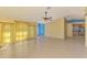 Spacious living room featuring tile floors, ceiling fan, and large windows with natural light at 3027 Ridgewood Dr, North Port, FL 34287