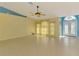 Bright living room with tile flooring, high ceilings, and double doors leading to front entry at 3027 Ridgewood Dr, North Port, FL 34287