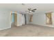 Main bedroom with ceiling fan, carpet flooring, and access door to outside at 3027 Ridgewood Dr, North Port, FL 34287
