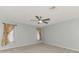 Spacious main bedroom features plush carpeting, a ceiling fan, and ample natural light at 3027 Ridgewood Dr, North Port, FL 34287