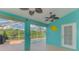 Patio with screen, ceiling fans, pool, and views of the lush backyard at 3027 Ridgewood Dr, North Port, FL 34287