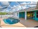 The backyard features a pool, screened-in patio, well-maintained concrete deck, and a white privacy fence at 3027 Ridgewood Dr, North Port, FL 34287