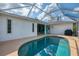 The backyard features a beautiful pool, screened-in lanai, and a concrete deck area at 3027 Ridgewood Dr, North Port, FL 34287