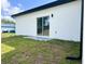 The exterior of the home features a sliding glass door and a small patio area at 3045 Montgomery Dr, Port Charlotte, FL 33981