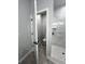 Bathroom with a walk-in shower featuring marble tile, black fixtures, and a separate toilet area at 3045 Montgomery Dr, Port Charlotte, FL 33981