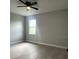 Bedroom with a ceiling fan, light gray walls and light gray wood-look flooring at 3045 Montgomery Dr, Port Charlotte, FL 33981
